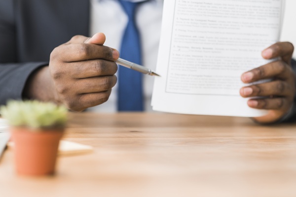 crop-ethnic-man-showing-papers