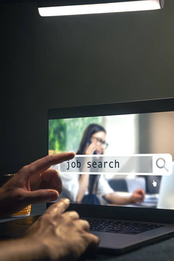 Man browsing job opportunities online using job search in computer application, unemployed man looking for new vacancies on website page on laptop screen.